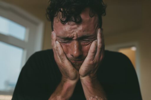 A person’s anguished face, symbolizing the frustration of dealing with low-quality leads.